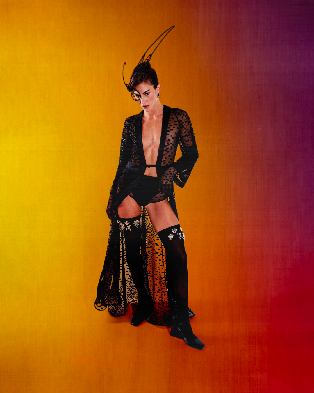 Clara Berry standing in Lumey Paris sheer black velvet-flocked tulle Kimono 11.14, Brief 11.14 and Gloves 11.14 against a sunset gradient backdrop, French luxury ready-to-wear