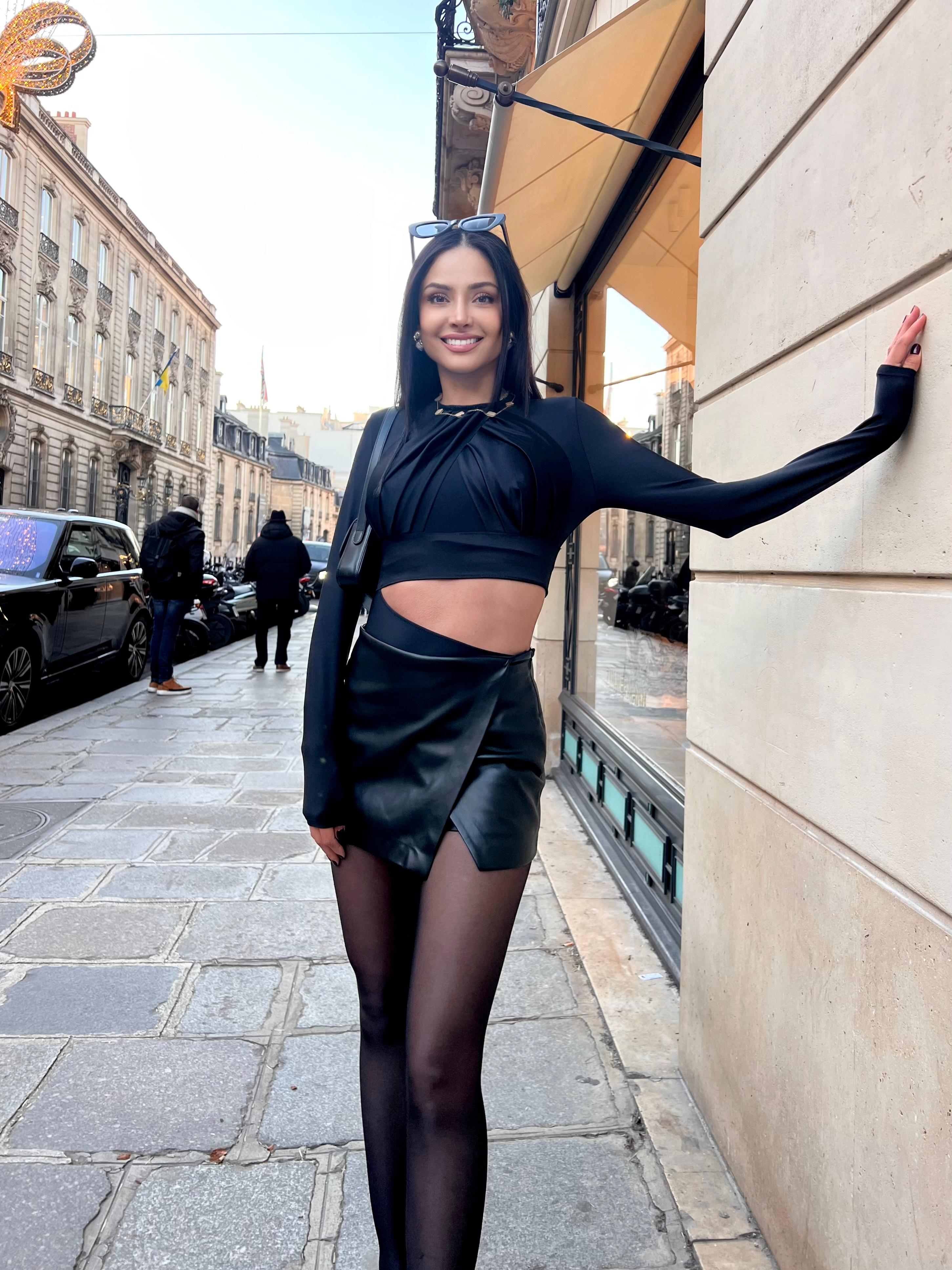 Patricia Contreras wearing the Lumey Paris 02.08 black cut-out bodysuit, styled with an oversized blazer and leather mini skirt, Paris street