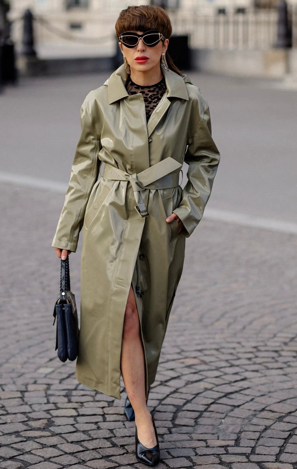 Salomé Chaboki street style — Lumey Paris 11.14 black flocked tulle top layered under an olive trench coat, Paris Fashion Week
